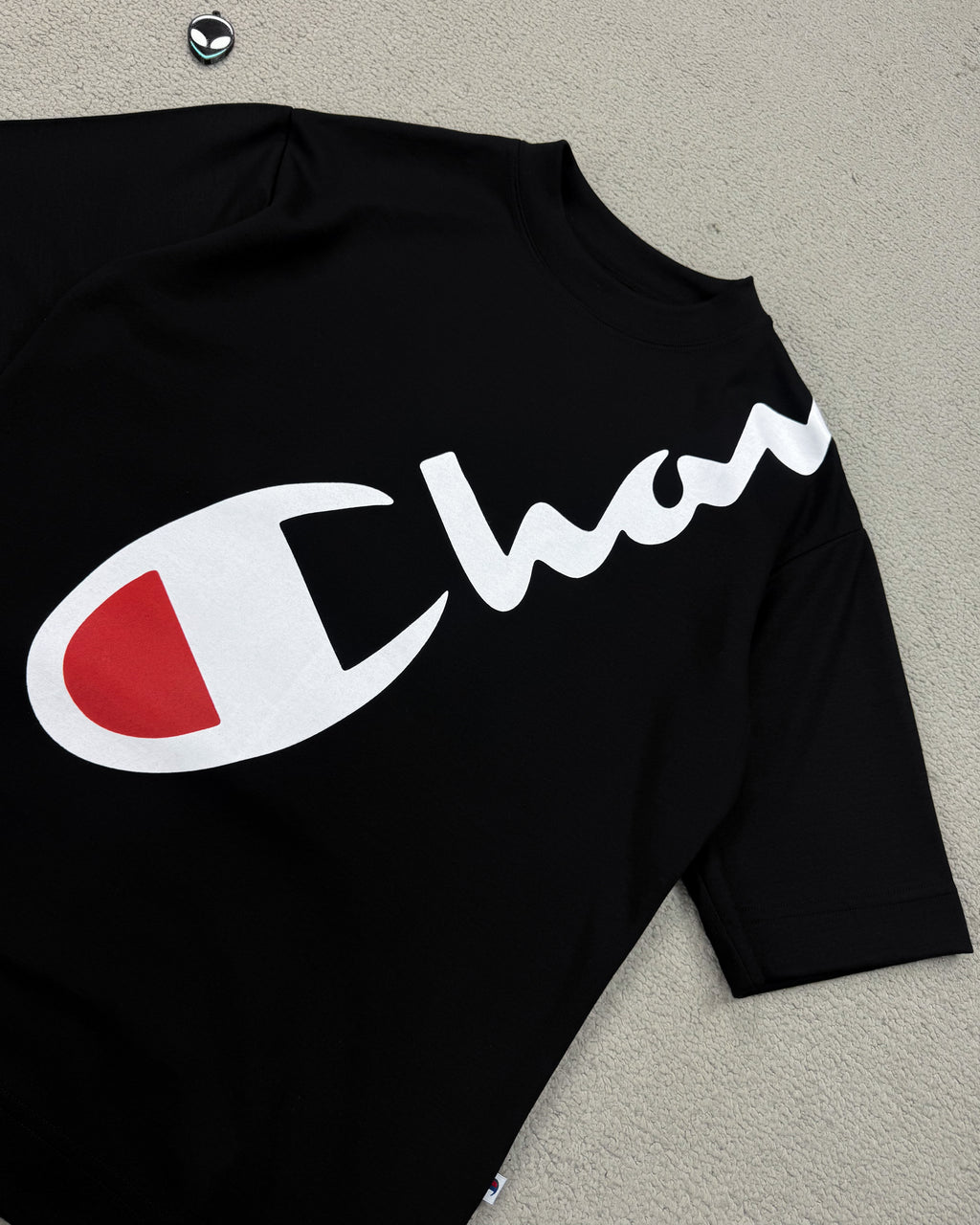 CAMISETA OVERSIZED CHAMP LETREIRO